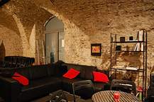 Tabou-Lounge mit schwarzer Sitzecke und roten Kissen